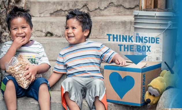 two boys sitting together smiling